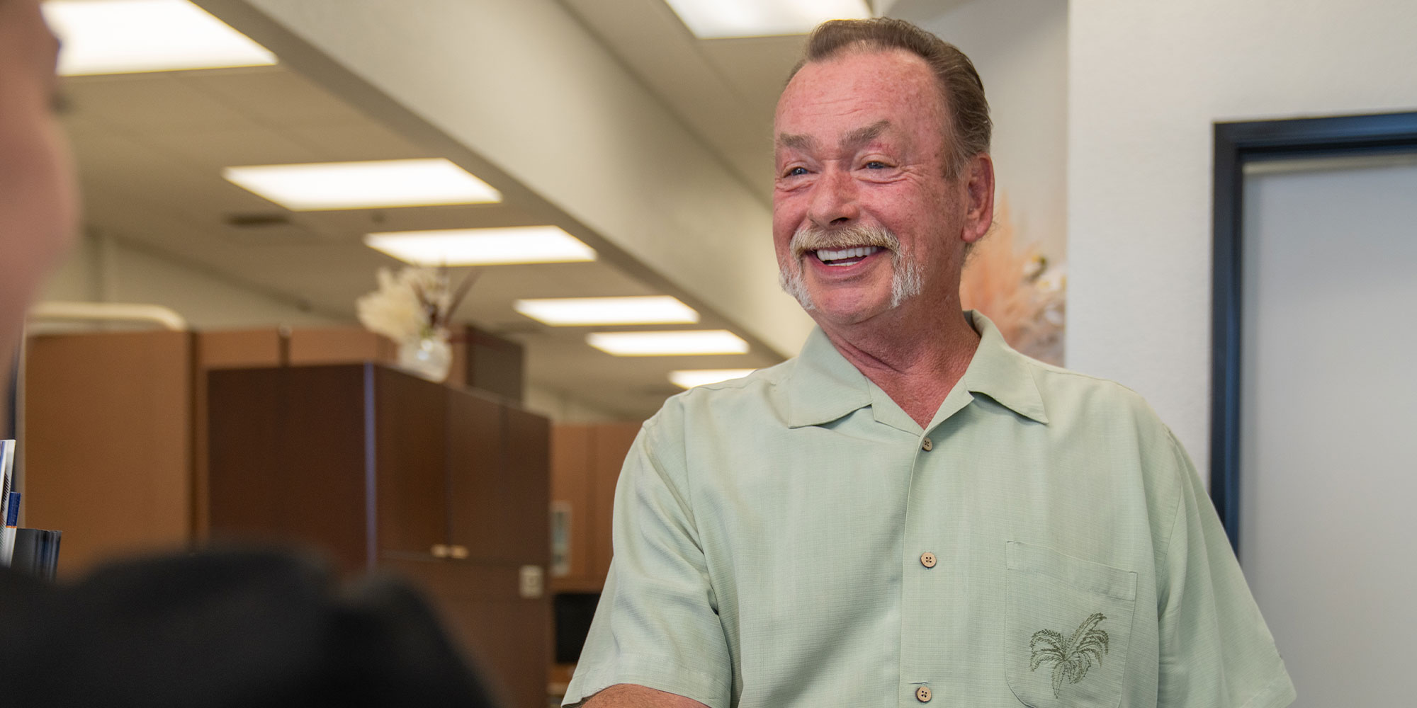 Patient smiling at team member