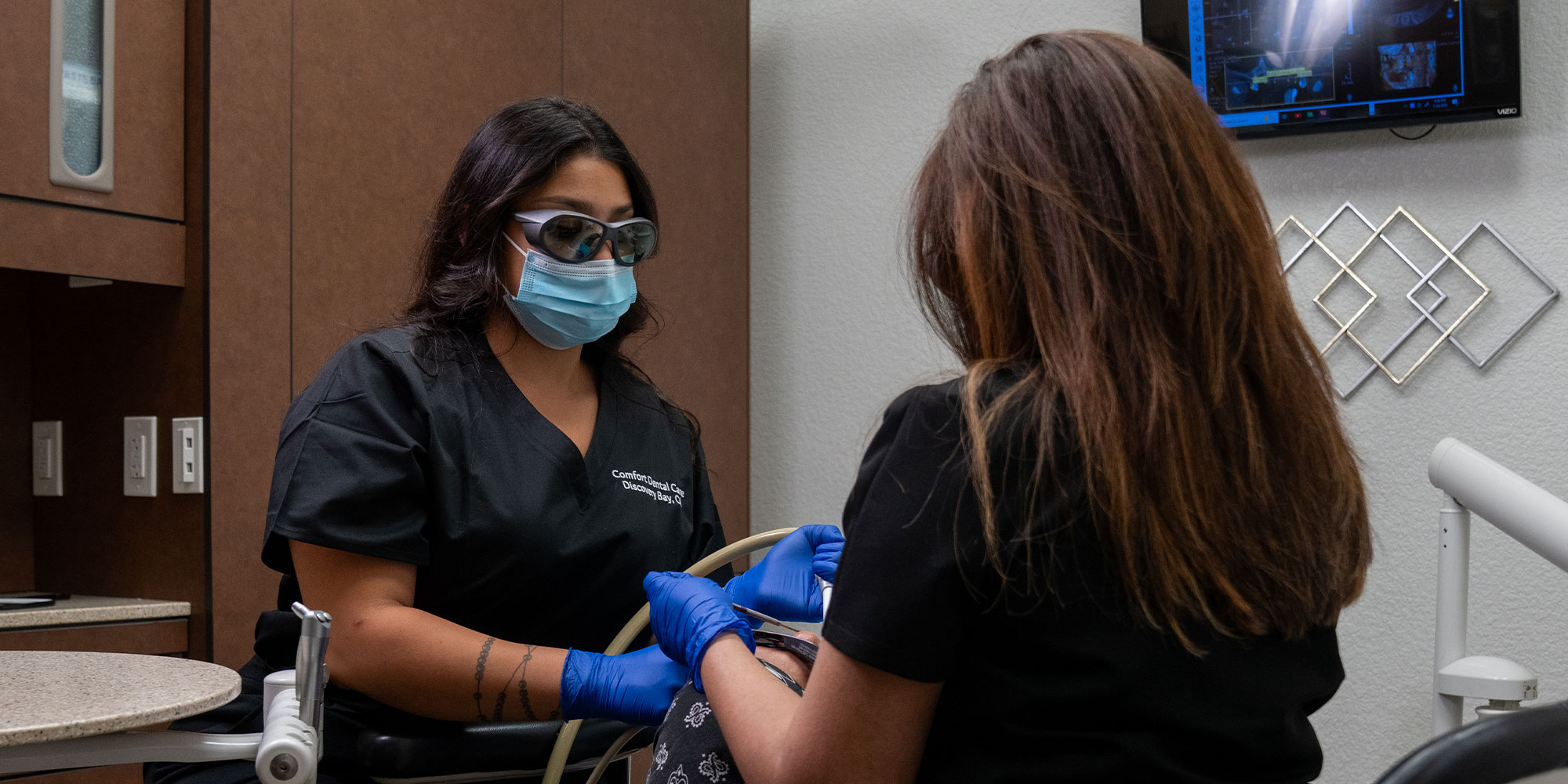 doctor in the middle of dental procedure working on patient