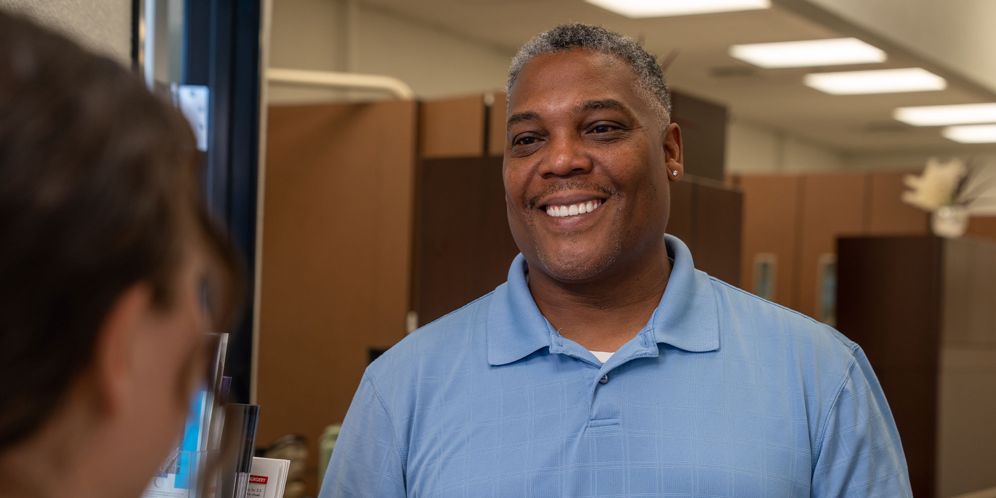 Paitent smiling at team member