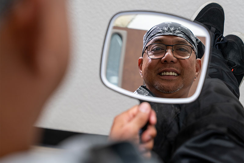 Patient smiling into mirror