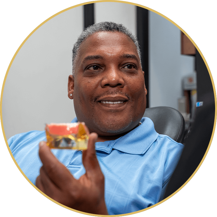 man holding dental implant